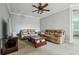 A spacious living room with neutral paint and carpet, leather sofas, and a ceiling fan at 9736 Hatton Cir, Orlando, FL 32832