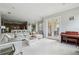 Open-concept living room with tile floors and access to the kitchen and outdoor patio at 9736 Hatton Cir, Orlando, FL 32832