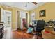 Office space with hardwood floors, a ceiling fan, and ample natural light through the windows at 9736 Hatton Cir, Orlando, FL 32832