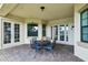 Inviting covered patio with brick flooring and comfortable seating, perfect for enjoying the outdoors at 9736 Hatton Cir, Orlando, FL 32832