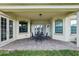 Covered patio with seating and doors leading inside at 9736 Hatton Cir, Orlando, FL 32832