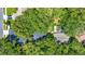 Expansive aerial view of a property featuring mature trees and a screened-in pool area at 1608 Victoria Way, Winter Garden, FL 34787
