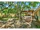 Backyard featuring mature trees, wood fence, garden, patio and a pergola at 1608 Victoria Way, Winter Garden, FL 34787