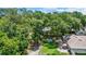 Aerial backyard view showcasing a lush green lawn, mature trees, fire pit and play area at 1608 Victoria Way, Winter Garden, FL 34787