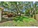 Backyard with a pergola, wood fence and mature trees providing plenty of shade at 1608 Victoria Way, Winter Garden, FL 34787