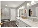 Elegant bathroom with double vanity, modern fixtures, and a glass-enclosed shower, offering a luxurious experience at 1608 Victoria Way, Winter Garden, FL 34787