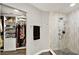Stylish bathroom with a glass-enclosed shower featuring modern fixtures and a built-in closet for ample storage at 1608 Victoria Way, Winter Garden, FL 34787