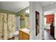 Cozy green bathroom featuring a shower with floral-themed curtain and a traditional vanity for daily use at 1608 Victoria Way, Winter Garden, FL 34787