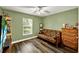 Green bedroom with a bright window, complemented by a futon and dresser, ideal for relaxation and storage at 1608 Victoria Way, Winter Garden, FL 34787