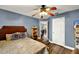 Comfortable blue bedroom with a ceiling fan and a view into the adjacent dining area, creating an inviting space at 1608 Victoria Way, Winter Garden, FL 34787