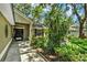 Front entrance with neatly landscaped garden and a stylish front door with black hardware at 1608 Victoria Way, Winter Garden, FL 34787