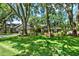 Charming home features lush lawn, mature trees, tidy landscaping, and a two-car garage at 1608 Victoria Way, Winter Garden, FL 34787