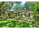 Charming home boasts a well-manicured lawn and mature trees shading the front yard and tidy garden at 1608 Victoria Way, Winter Garden, FL 34787