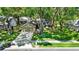 Charming home features lush lawn, mature trees, tidy landscaping, and a two-car garage at 1608 Victoria Way, Winter Garden, FL 34787