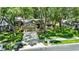 Charming home features lush lawn, mature trees, tidy landscaping, and a two-car garage at 1608 Victoria Way, Winter Garden, FL 34787