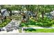 Charming home features lush lawn, mature trees, tidy landscaping, and a two-car garage at 1608 Victoria Way, Winter Garden, FL 34787