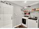 Laundry Room with washer, dryer, wire shelves, and access door to the exterior at 1608 Victoria Way, Winter Garden, FL 34787