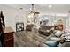 Open-concept living room with hardwood floors, bright lighting, and ceiling fan flowing into the kitchen and dining area at 1608 Victoria Way, Winter Garden, FL 34787
