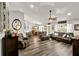 Spacious living room featuring hardwood floors, neutral walls, and lots of natural light perfect for relaxation and entertainment at 1608 Victoria Way, Winter Garden, FL 34787