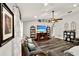 Cozy living room with a fireplace, ceiling fan, and hardwood floors offering a warm and inviting atmosphere at 1608 Victoria Way, Winter Garden, FL 34787