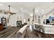 Open-concept living area with hardwood floors, neutral walls, and ceiling fan with easy access to the kitchen and dining room at 1608 Victoria Way, Winter Garden, FL 34787