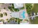 Overhead view of the community pool, marina, lush landscaping, parking, and the condo building's architectural details at 1 Riverwalk Dr # 303, New Smyrna Beach, FL 32169