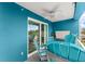 Outdoor patio with blue walls and a table and chairs overlooking a green space at 1 Riverwalk Dr # 303, New Smyrna Beach, FL 32169