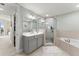 Bathroom featuring a glass shower, large tub, and double sinks with modern fixtures at 1 Riverwalk Dr # 303, New Smyrna Beach, FL 32169
