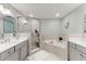 Bright primary bath with dual sinks, separate soaking tub, and glass enclosed shower at 1 Riverwalk Dr # 303, New Smyrna Beach, FL 32169