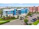 A detailed view of the building's facade, enhanced with landscaping, lush greenery, and ample parking space at 1 Riverwalk Dr # 303, New Smyrna Beach, FL 32169