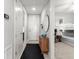 Bright hallway with a decorative wooden cabinet leading to a bedroom with bunk beds, creating a cozy and inviting space at 1 Riverwalk Dr # 303, New Smyrna Beach, FL 32169