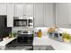 Elegant kitchen with stainless steel appliances, white cabinetry, and ample countertop space, perfect for culinary enthusiasts at 1 Riverwalk Dr # 303, New Smyrna Beach, FL 32169