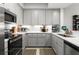 Modern kitchen featuring stainless steel appliances, gray cabinets, and ample counter space for cooking and entertaining at 1 Riverwalk Dr # 303, New Smyrna Beach, FL 32169