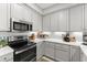 Well-appointed kitchen with stainless steel appliances, white cabinets, and a cozy breakfast nook, creating a welcoming space at 1 Riverwalk Dr # 303, New Smyrna Beach, FL 32169