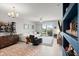 Bright and airy living room featuring a white couch, stylish bar, and access to the outdoor balcony at 1 Riverwalk Dr # 303, New Smyrna Beach, FL 32169
