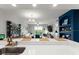 Open-concept living room featuring a modern kitchen with a bar, comfortable seating, and a beautiful view at 1 Riverwalk Dr # 303, New Smyrna Beach, FL 32169