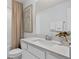Bathroom vanity with white quartz countertop, chrome fixtures, and decorative wall art at 10154 Hadley St, Orlando, FL 32829