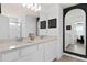 Bathroom with double sink vanity, quartz countertops, and a modern, large-format dark framed mirror at 10154 Hadley St, Orlando, FL 32829