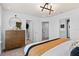 Bright bedroom featuring a dresser, walk-in closet, and a view into the en suite bathroom at 10154 Hadley St, Orlando, FL 32829
