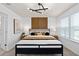 Stylish bedroom with a black bed frame, modern lighting, and a decorative wood panel accent wall at 10154 Hadley St, Orlando, FL 32829