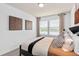 Bedroom with modern patterned pillows and window with bright natural light at 10154 Hadley St, Orlando, FL 32829