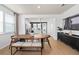 Bright dining area with modern table and chairs, complemented by an open view of the kitchen and contemporary decor at 10154 Hadley St, Orlando, FL 32829