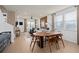 Open concept dining area with modern table, leading to the living room and creating a spacious, connected living space at 10154 Hadley St, Orlando, FL 32829