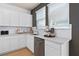 Bright kitchen featuring modern appliances, white cabinets, and quartz countertops at 10154 Hadley St, Orlando, FL 32829