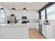 Contemporary kitchen with quartz countertops, stainless steel appliances, and herringbone backsplash at 10154 Hadley St, Orlando, FL 32829