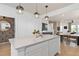 Bright modern kitchen with a large island, pendant lighting, and stainless steel appliances at 10154 Hadley St, Orlando, FL 32829
