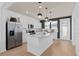 Well-lit kitchen features stainless steel appliances, white cabinets, and an island at 10154 Hadley St, Orlando, FL 32829