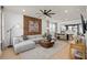Bright and airy living room featuring modern decor, a large sectional sofa, and an open-concept layout at 10154 Hadley St, Orlando, FL 32829