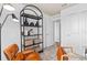 Office space featuring a modern glass desk and a stylish black bookcase at 10154 Hadley St, Orlando, FL 32829