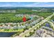 A sprawling community featuring single-Gathering homes, verdant trees, and scenic ponds, near a main thoroughfare at 10252 Kristen Park Dr, Orlando, FL 32832